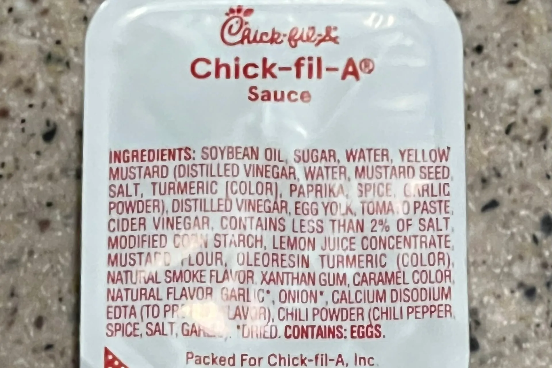 A sealed cup of Chick-fil-A Sauce