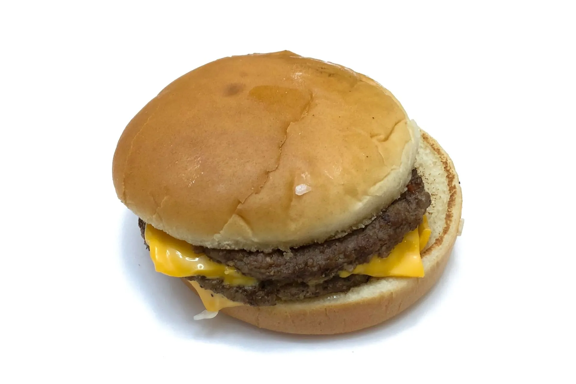 A Double Cheeseburger on a white background, with its top bun set to one side