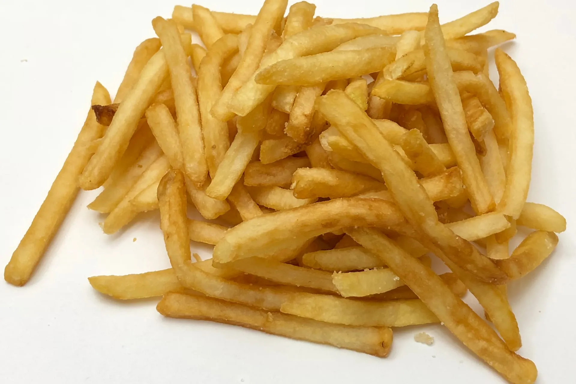 A pile of McDonald's fries on a white table