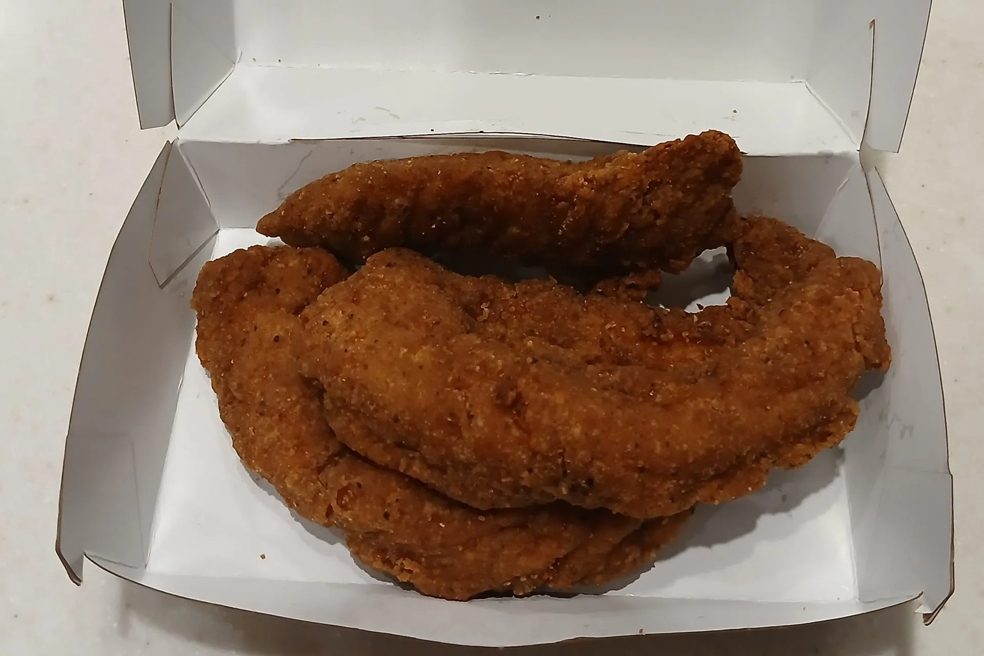 Three McCrispy Strips in an open box