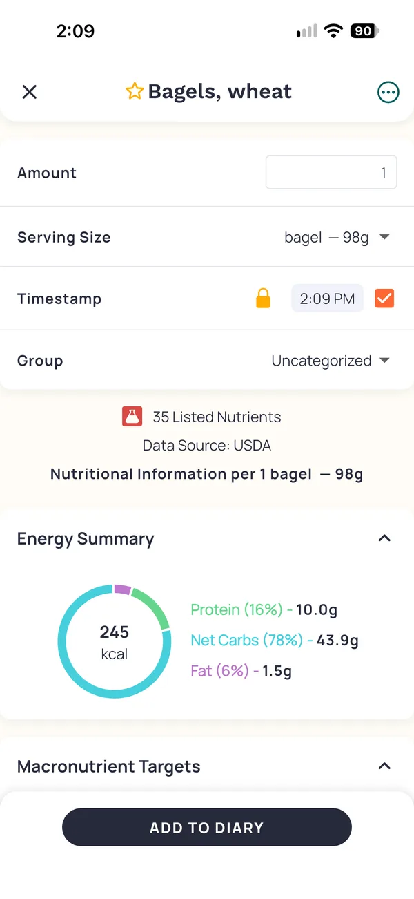 Cronometer's entry for Bagels, wheat, a 98 gram bagel at 245 calories. Beside a lab flask icon it reads 35 Listed Nutrients, Data Source USDA.